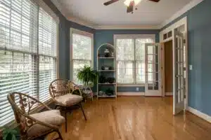 Bright sunroom with wooden flooring showcasing quality shutter installation cost in Plaistow from London Essex Shutters and Blinds