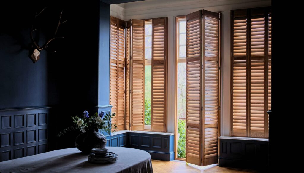 Elegant living room featuring luxury full-height shutters installed in London.