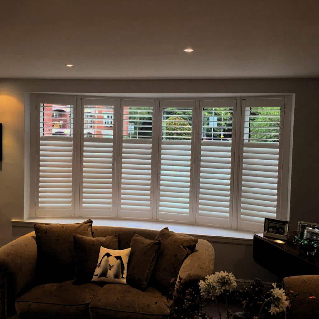 Beautiful white shutter installation in Stratford by London Essex Shutters and Blinds, featuring custom-fitted plantation shutters on a bay window