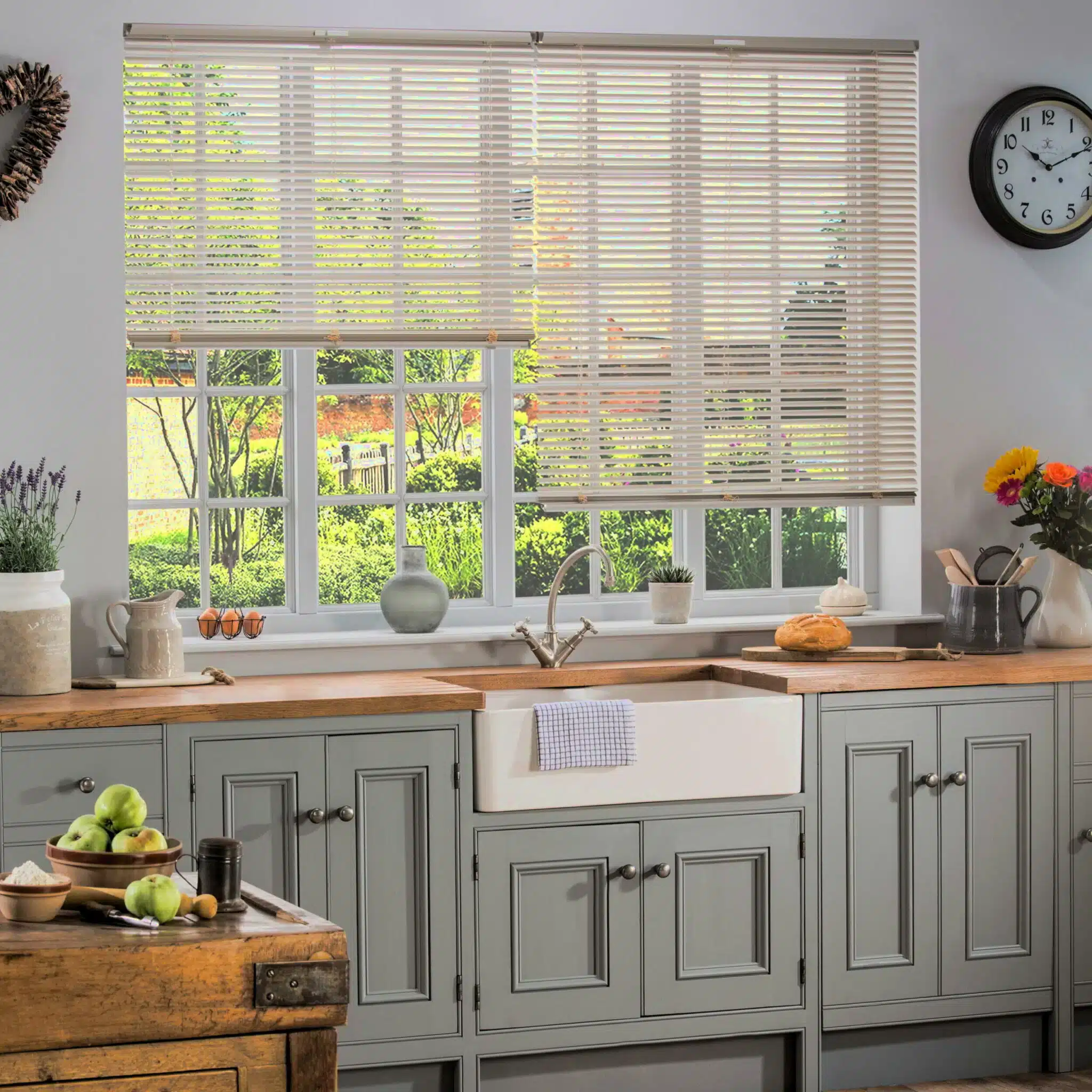 Professional shutter installation in West Hanningfield kitchen featuring elegant wooden blinds above a farmhouse sink with garden view