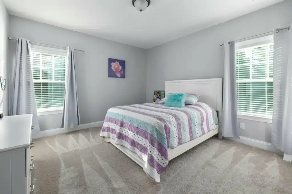 Full-height shutters representing classical and contemporary shutter styles Essex in a modern living room.