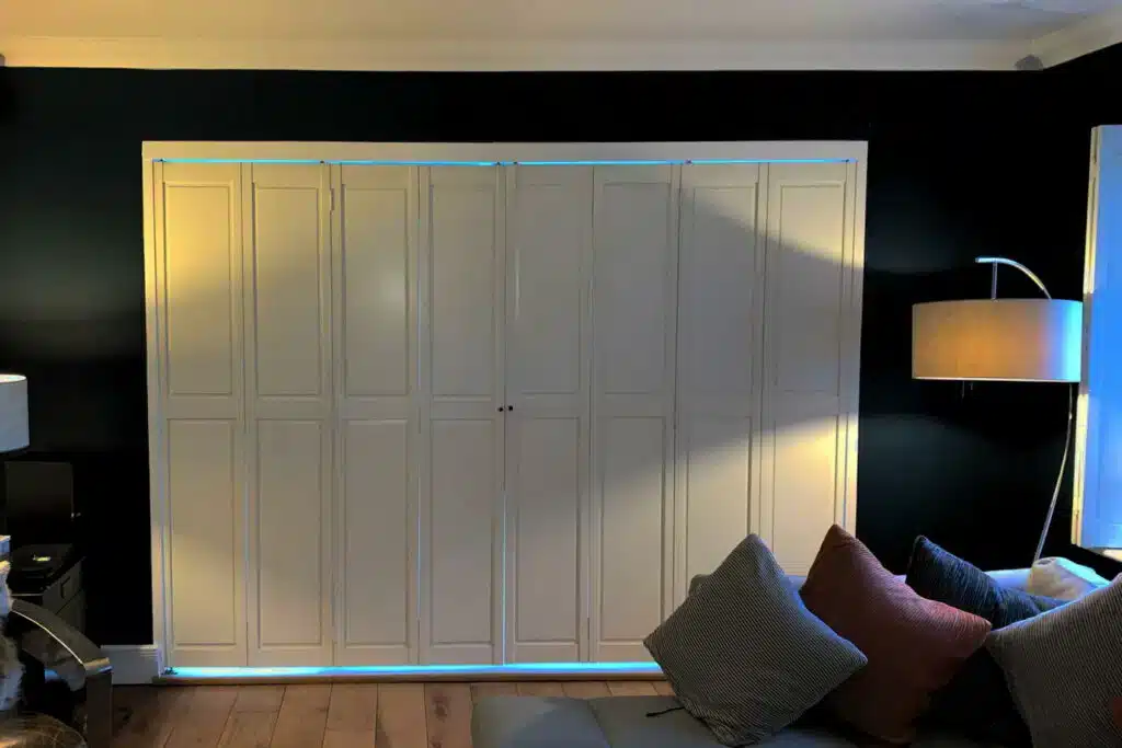 Custom white paneled Shutter Installation in Wanstead featuring elegant ambient lighting and modern design by London Essex Shutters and Blinds