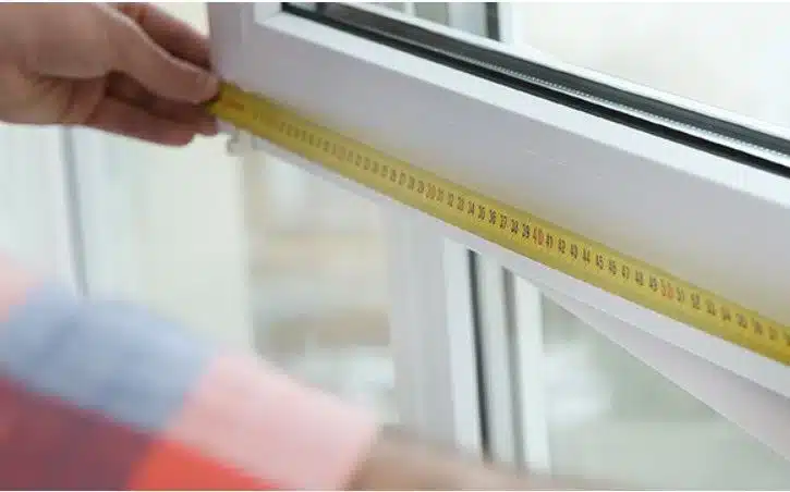 Professional measuring window frame for bespoke shutter installation cost in Orsett